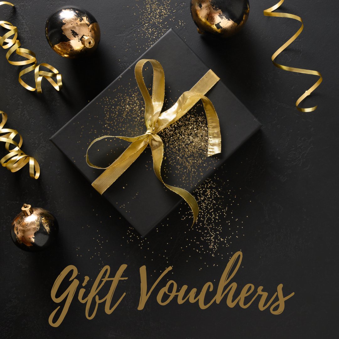 A present wrapped in black paper with Gift Vouchers written in gold text